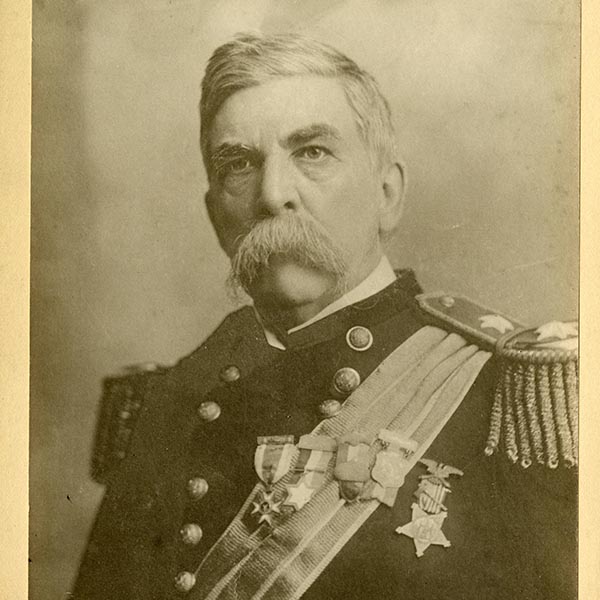 A service member in a decorated military uniform poses for a historical portrait.